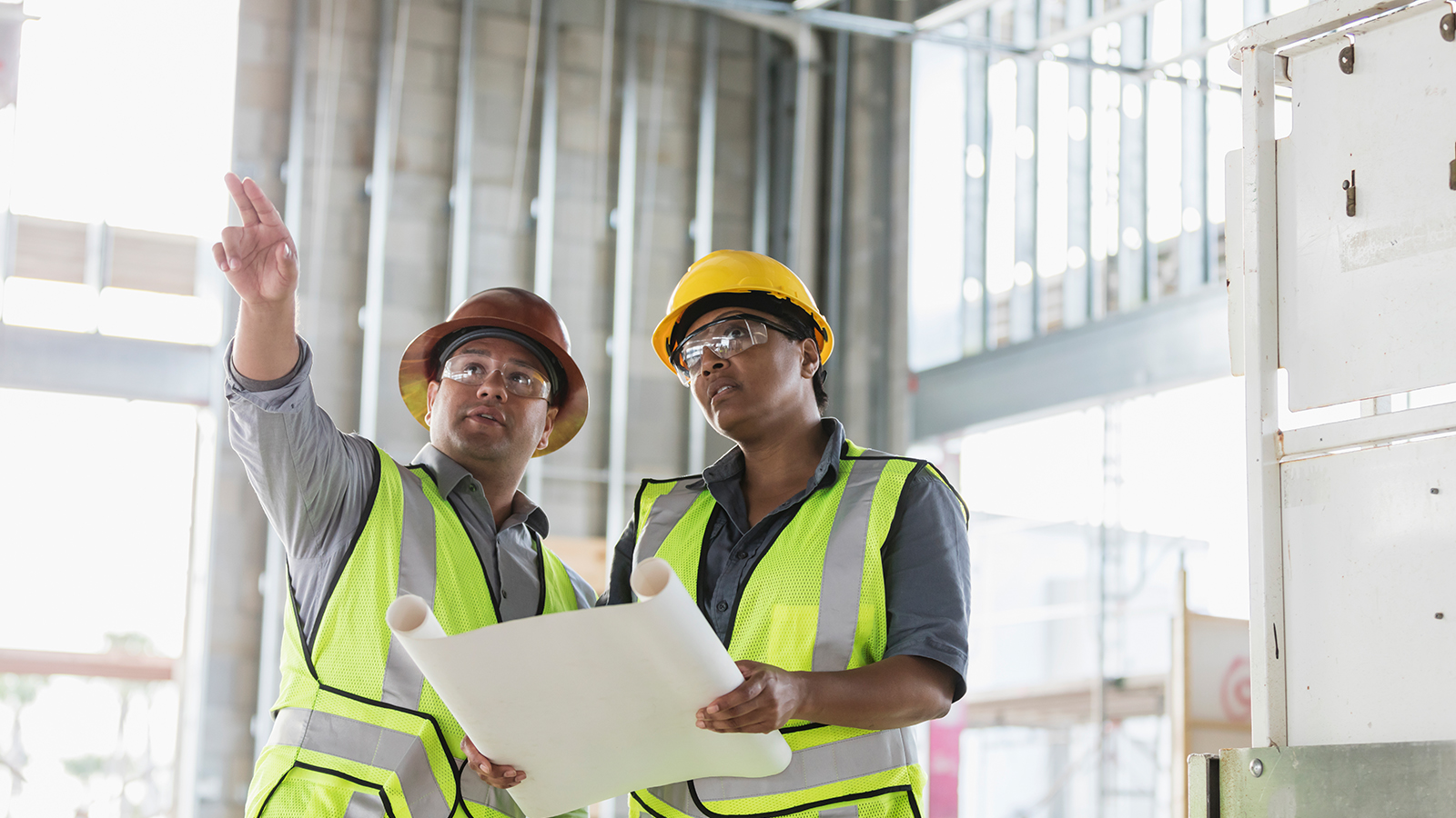 Two construction workers at construction site.