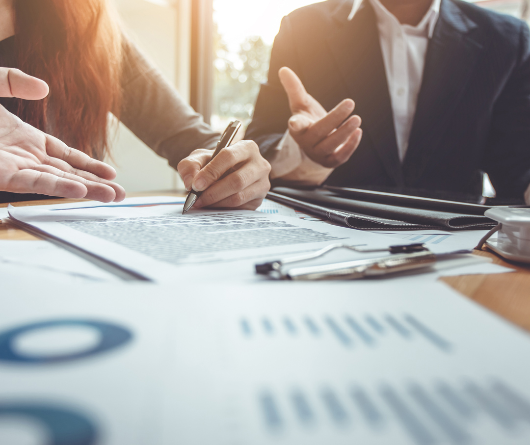 Image of a business people having a meeting taking notes.