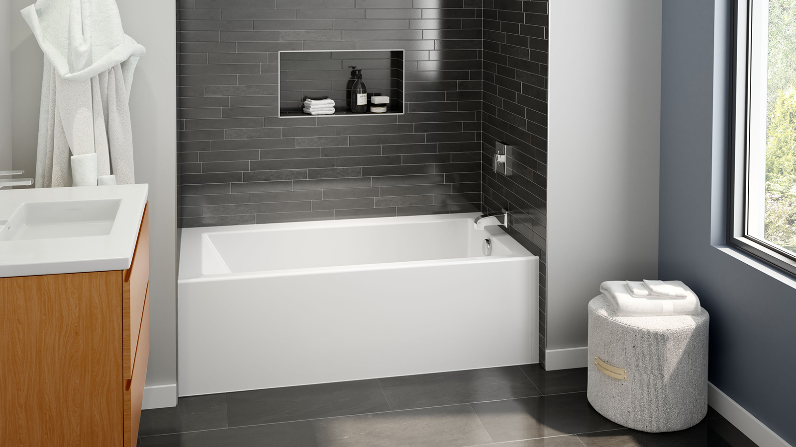 Beautiful white rectangular tub with stainless steel faucet and bathware accessories, surrounded by modern dark gray wall surround from Swan's Veritek Professional Collection