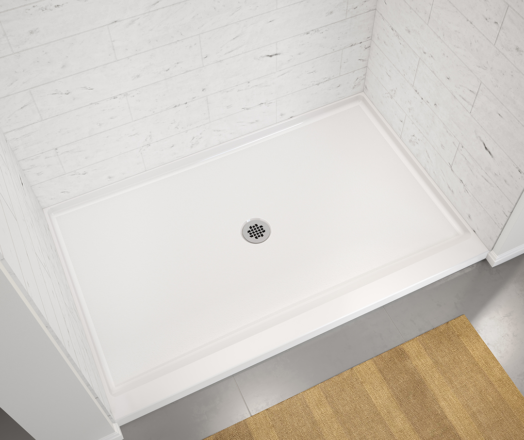 White shower pan with center drain shower with a wood floor.