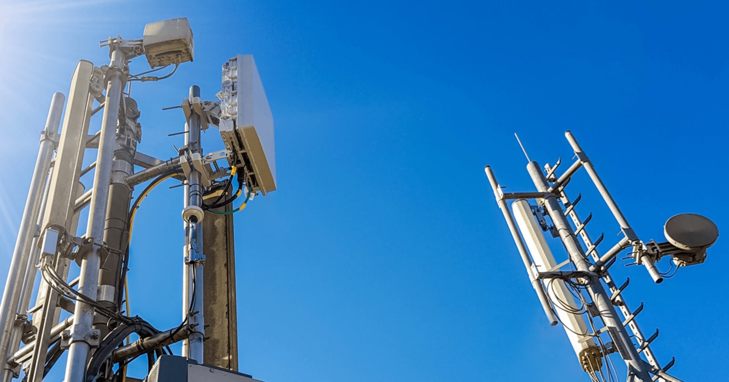 Cell towers against a blue sky.