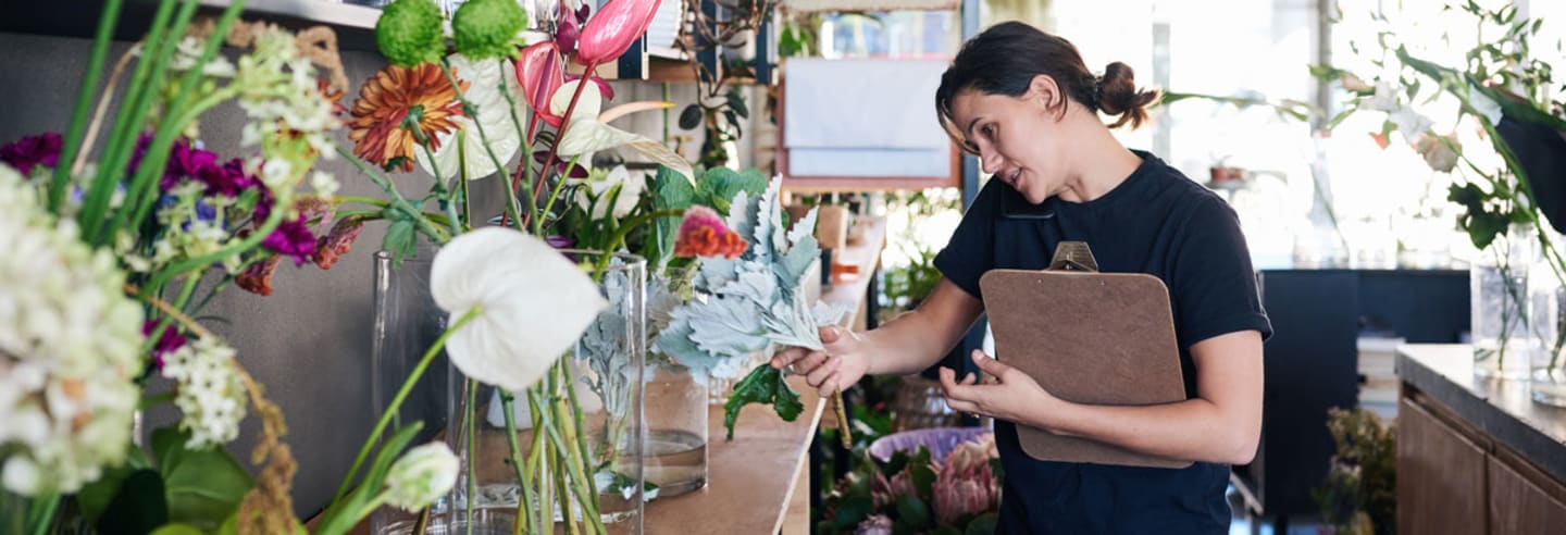 Small business owner working in shop.