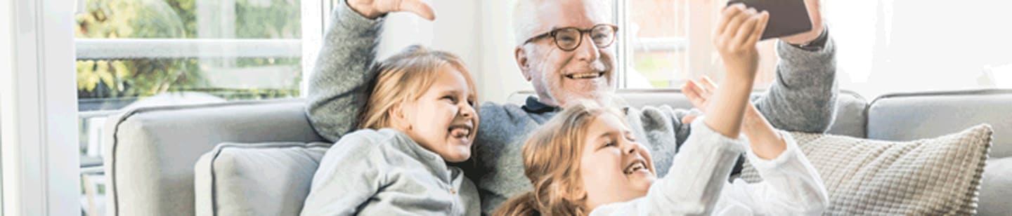 A grandfather enjoying time with his granddaughters.