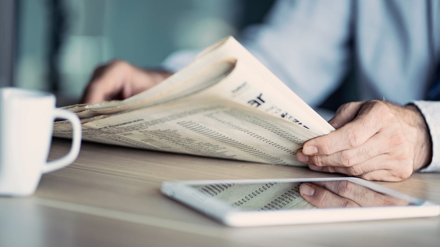 Person reading newspaper.