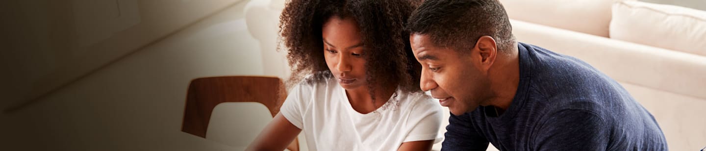 Father and daughter at kitchen table.
