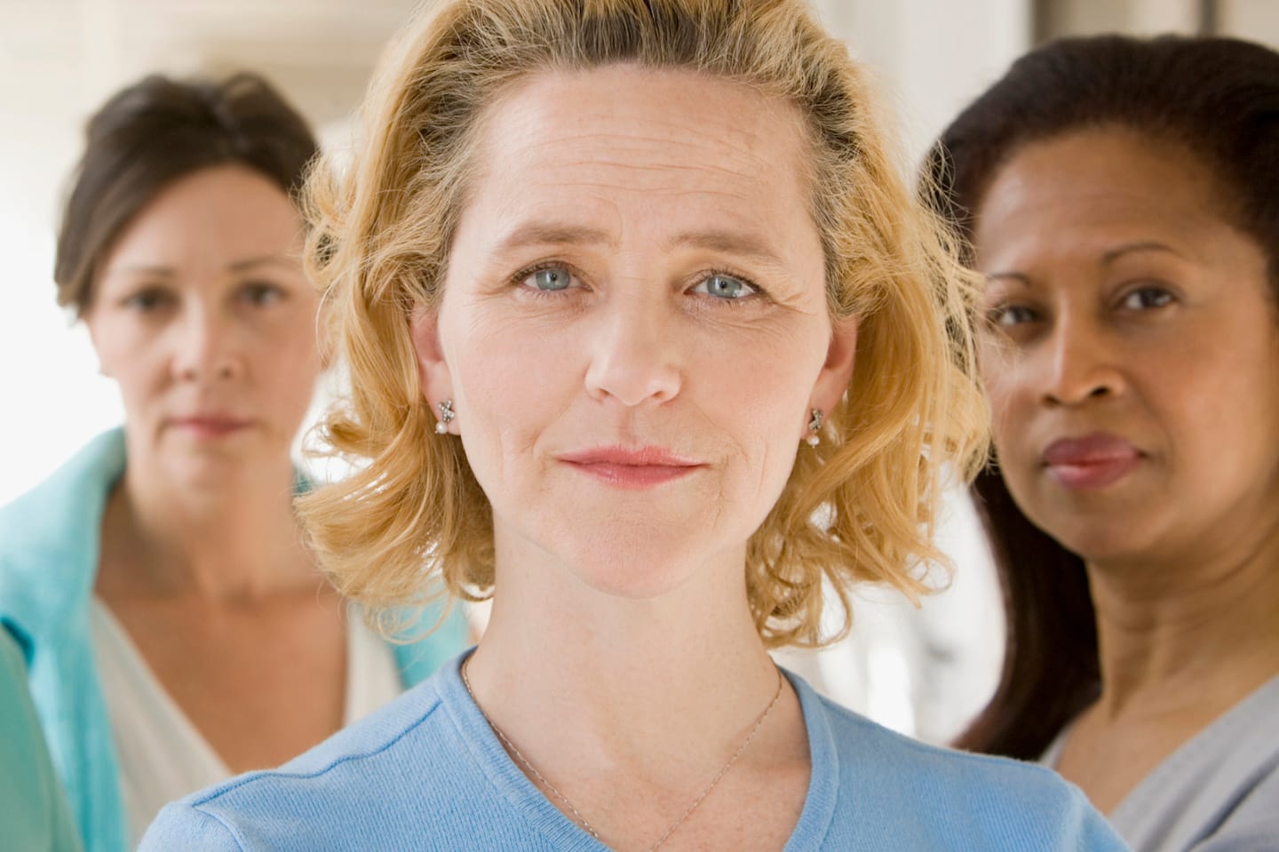 Three women looking into the camera.