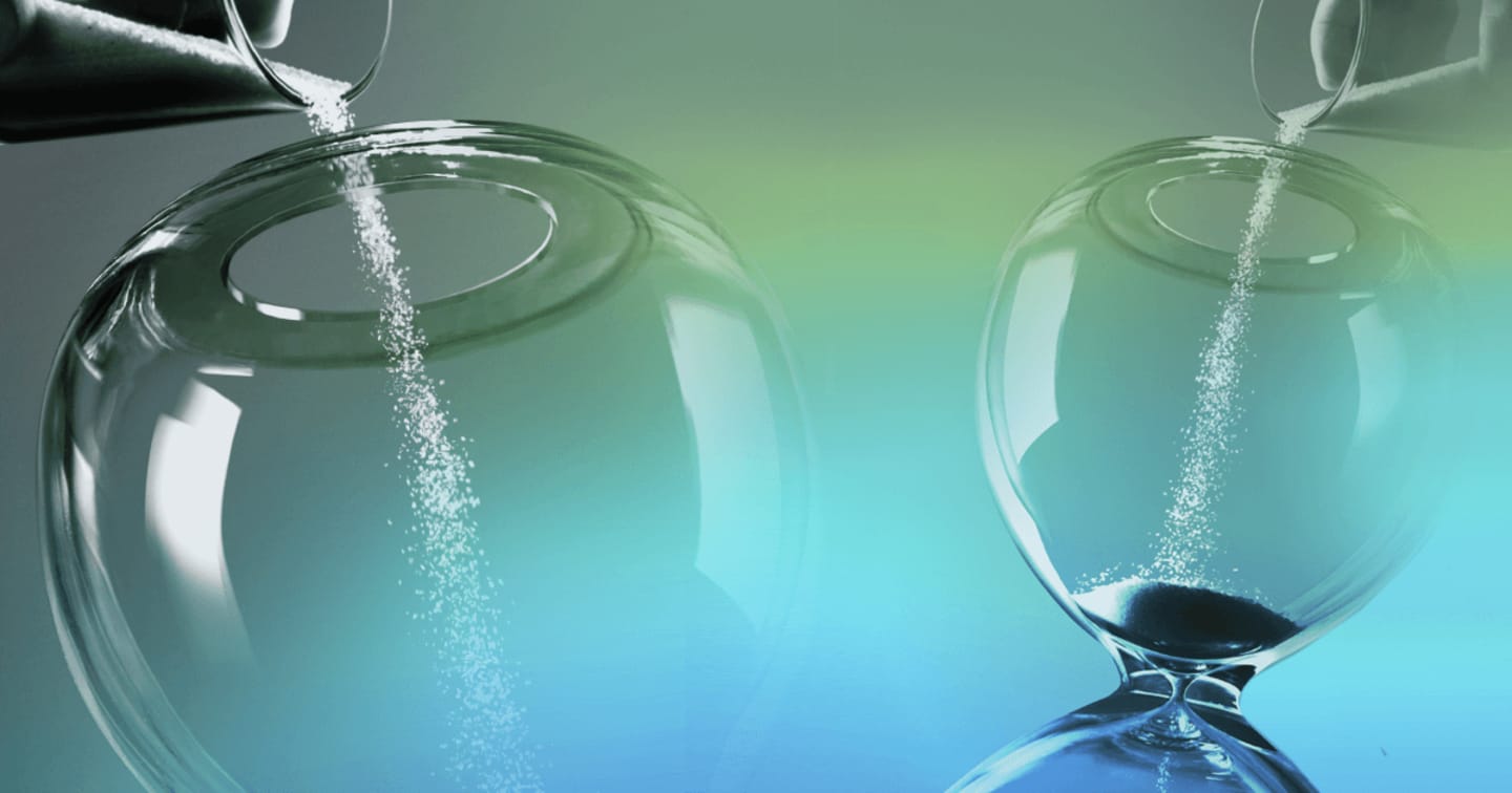 Abstract image of sand being poured into the top of an hourglass
