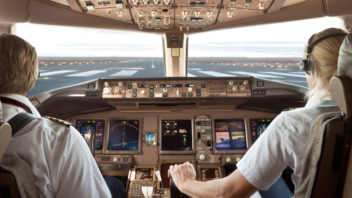 Two pilots in cockpit of airplane.