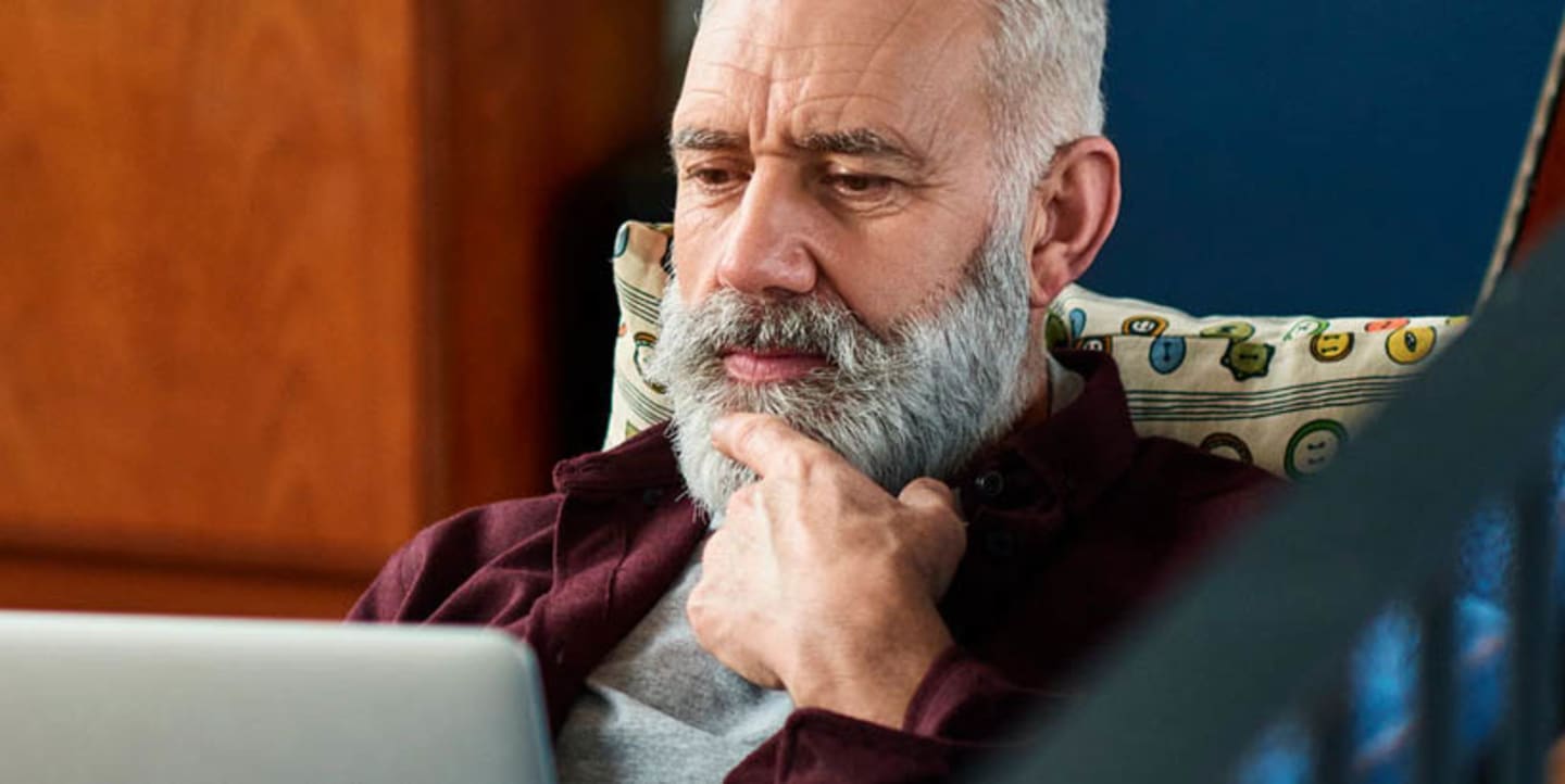 An older man looking at his computer screen.
