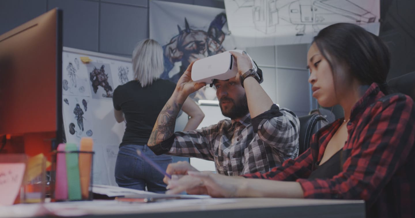 Game developers working on virtual reality technology.