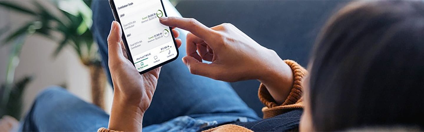 Person lounging on couch browsing mobile app.