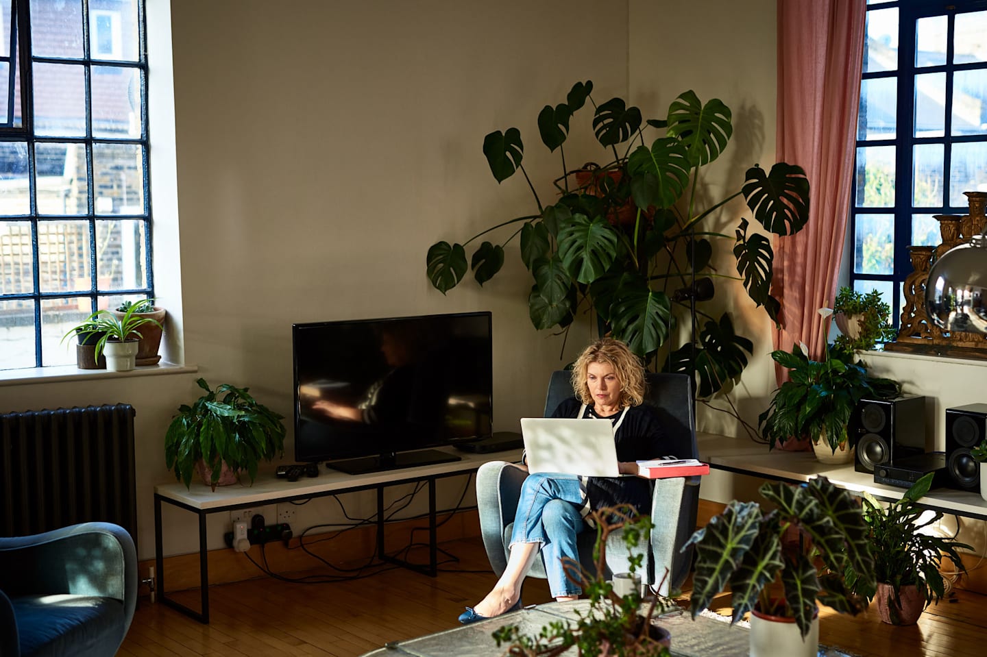 Woman on laptop sitting in living room.