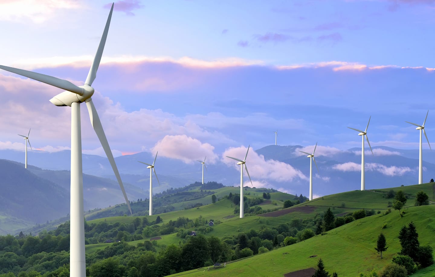 Scenic landscape with several wind turbines.