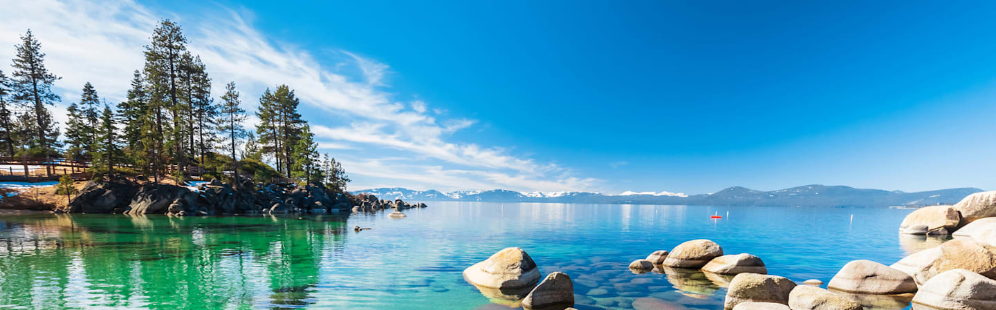 Clear lake with mountains in the background.