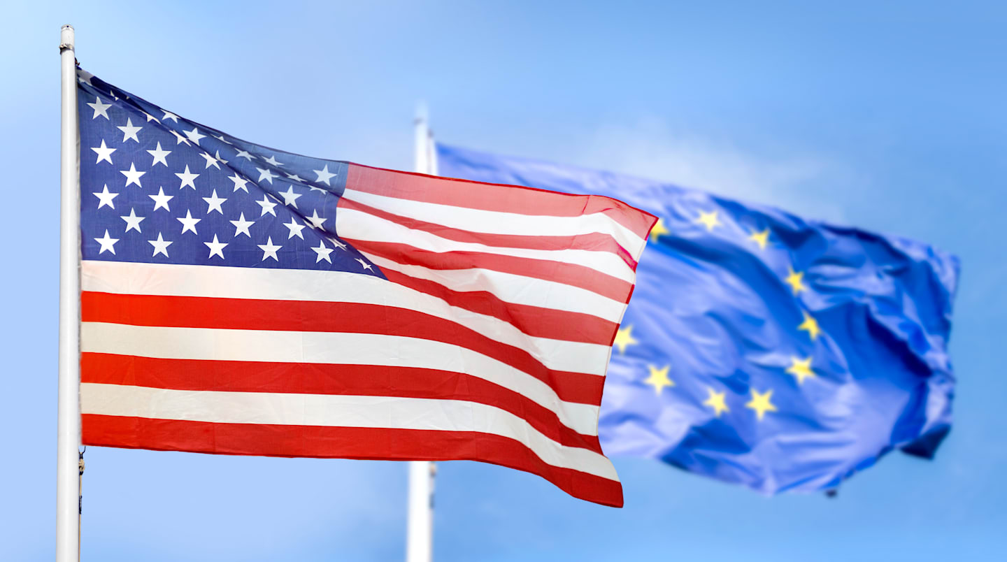 United States and Eurozone flags.