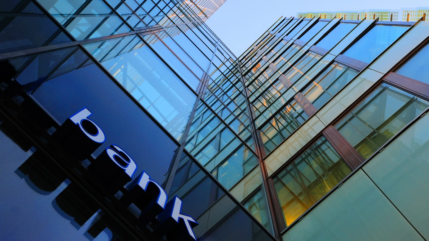 Looking up at a skyscraper labeled 'bank'.