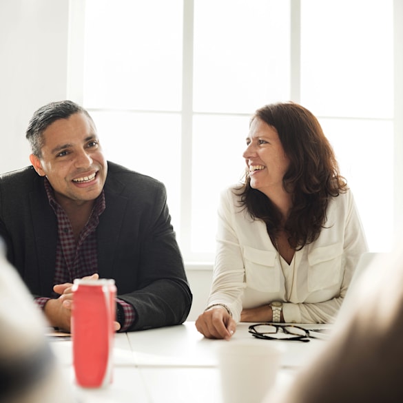 Man and woman enjoying each other's company at a table.