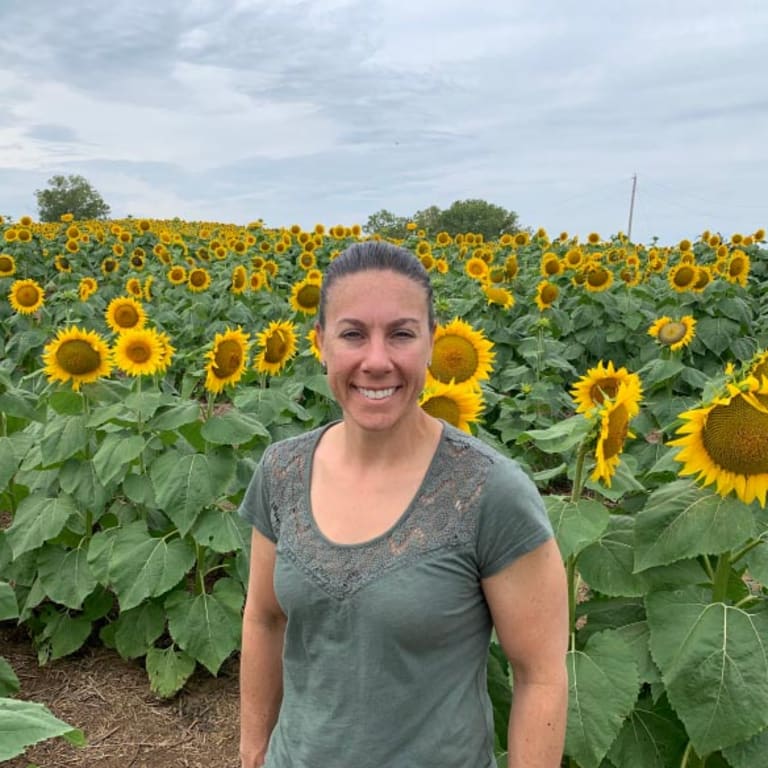 image of girl smiling with sunflower background