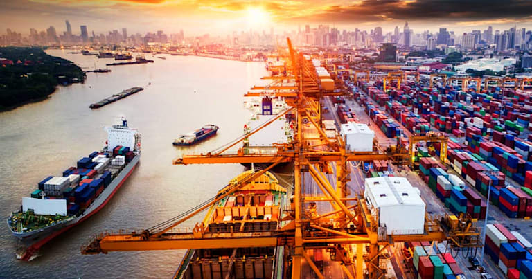 Aerial view of shipping harbor by city.