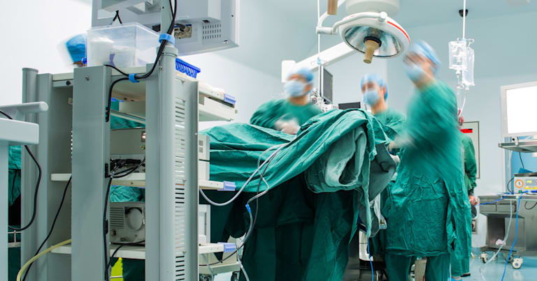 Surgeons working in operating room.