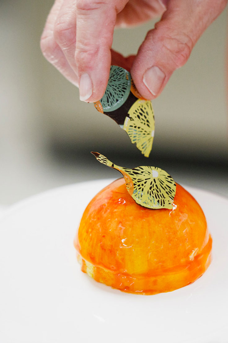 garnishing a glazed dome cake