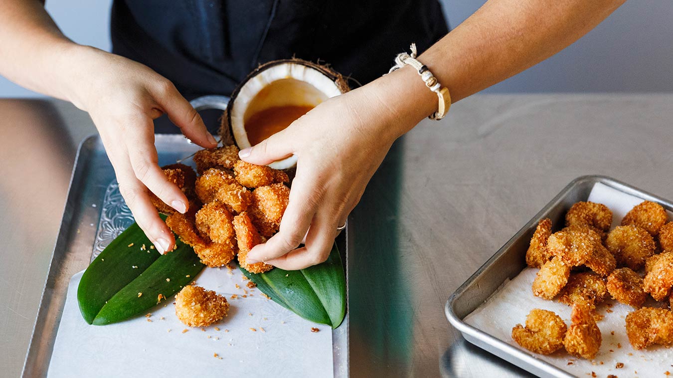 Amoretti Recipe: Coconut Shrimp with Pineapple Sauce. Plating our shrimp on a few lovely green leaves.