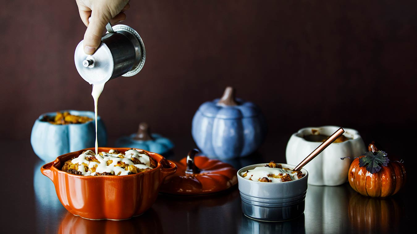 Amoretti Pumpkin Spice & Pear Bread Pudding Recipe, pouring Pear Anglaise over pudding