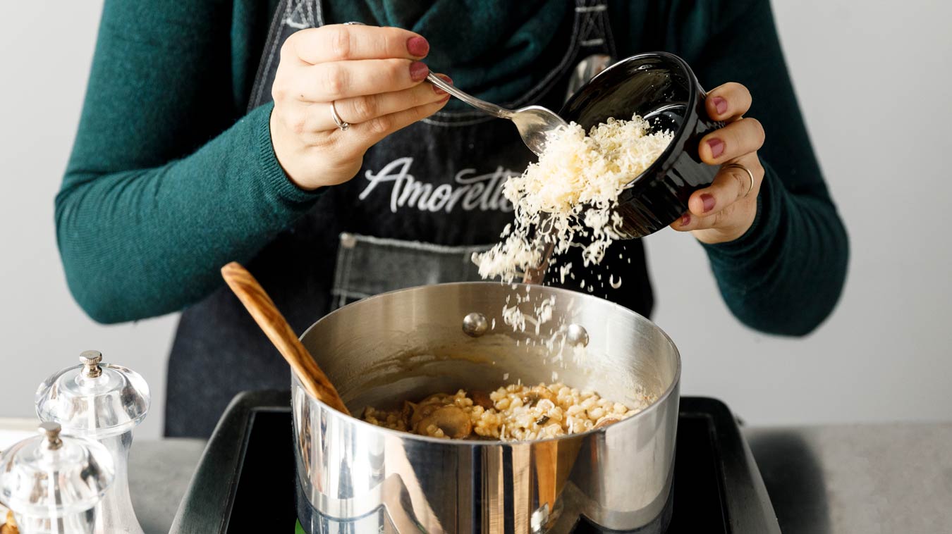 Amoretti Recipe: Barley Risotto with Mushrooms and Parmesan. Add parmesan.