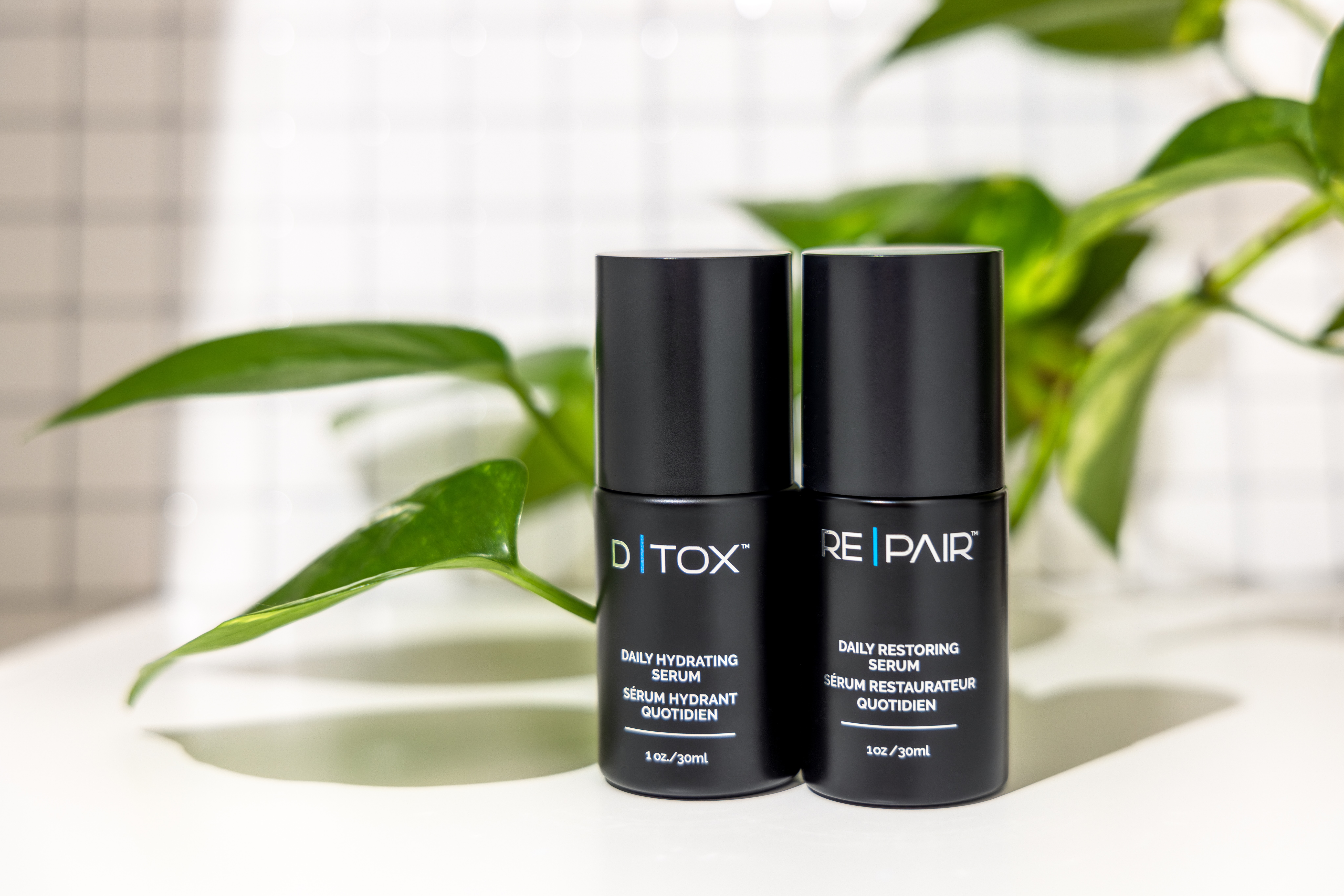 D|TOX and RE|PAIR bottles with plant