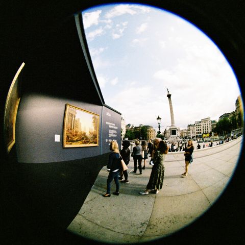 Members of the public interacting with the National Gallery installation on the  square. Early afternoon sun.