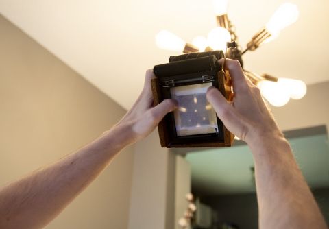 Testing the new lens on the Gingerbread 2 camera. Notice how the chandelier is projected onto the piece of semitransparent parchment paper.