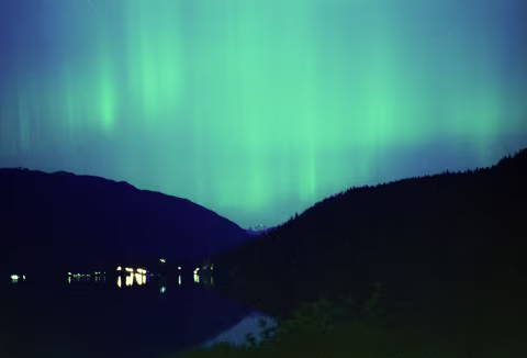 Aurora borealis on CineStill 800T pushed +3 stops to 6400 with Pentax K 1000 and a 50mm Pentax-A 1:1.7. This image was exposed for 5s at f/2.