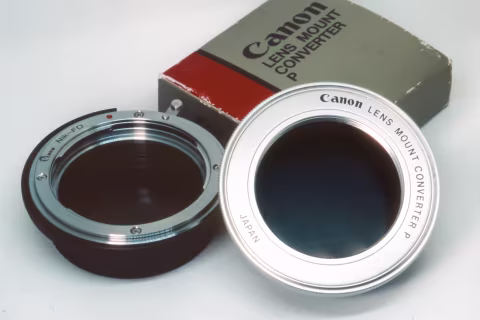 Adaptors for non-FD lenses: on the left, for F-mount lenses to an FD-mount camera (third party adaptor) and on the right, Canon-made adaptor for M42-mount lenses to FD-mount camera. This photograph is taken with a Nikon F5 and a Macro Tokina AF 100 mm f./2.8 on Fujichrome Provia 100F.