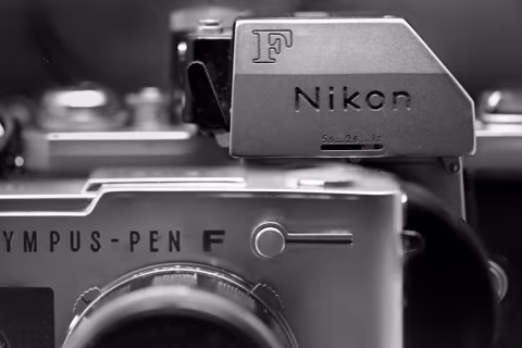 The PEN FV and a Nikon FTn behind it, almost dwarfing the PEN camera.