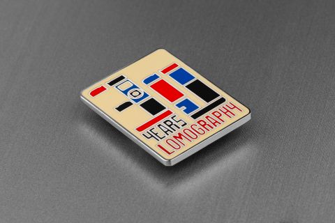 Lomography’s 30-year anniversary metal pin. The brand also sells identical design as a fridge magnet and a sticker.
