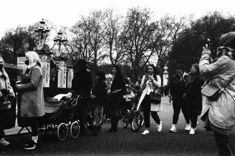 People at the gates, Buckingham Palace, London, 9-10 April 2021. Taken with the Canon EF camera and a Tamron 70-150 mm f./3.8 lens on Eastman Double-X film.
