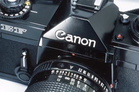 The Canon brand name on the pentaprism housing. Taken with a Nikon F5 and a Macro Tokina AF 100mm f./2.8 on Fujichrome Provia 100F.