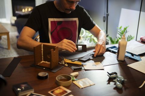 Putting together the sliding paper shutter assembly.