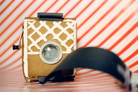 A lens made out of isomalt sugar, mounted on an edible instant film camera, “Gingerbread 2.”