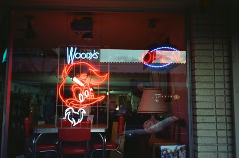 Neon Sign Illuminating the Window of an Antique Shop in Orange County, California. Taken with a Yashica T5 and CineStill 800T film.
