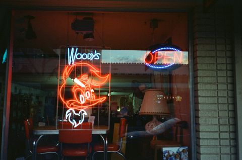 Neon Sign Illuminating the Window of an Antique Shop in Orange County, California. Taken with a Yashica T5 and CineStill 800T film.