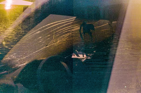 Accidental story: A crashed car drives into the sea at sunset, and the waves blend with the window cracks. Expired Kodak Vision 800T.