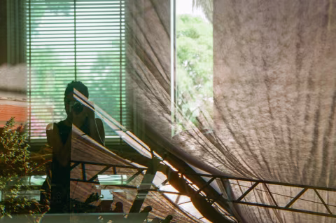 Accidental story: Me, reflected in a garden mirror, which is being haunted by an abandoned tent. Fuji 200.