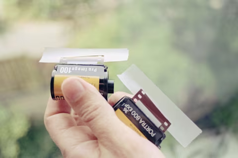 I use frosted tape to fasten film onto used film cartridges.