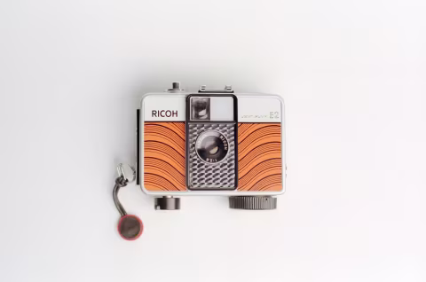 Ricoh Auto Half E2 in fancy orange wave design.