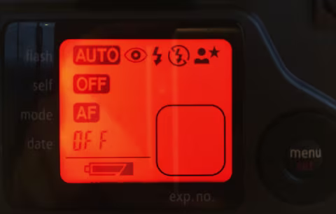 The menu screen turns orange as you cycle through the settings. The rounded square in the bottom-right would typically have an oversize frame number indicator, but in this case, I don’t have the film in the camera, so it’s empty.