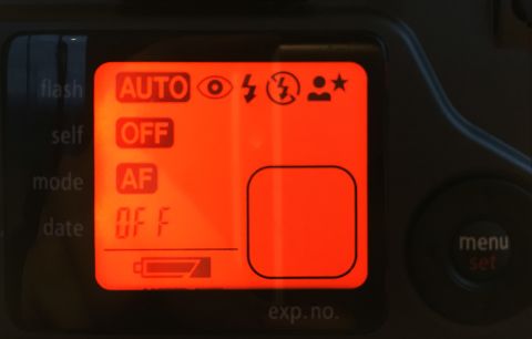 The menu screen turns orange as you cycle through the settings. The rounded square in the bottom-right would typically have an oversize frame number indicator, but in this case, I don’t have the film in the camera, so it’s empty.