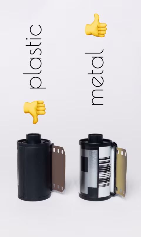 Plastic 35mm film canister (left, plain black surface) vs. metal 35mm film canister (right, with a DX code and a bar code).