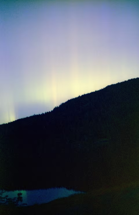 Aurora borealis on CineStill 800T pushed +3 stops to 6400 with Pentax K 1000 and a 50mm Pentax-A 1:1.7. This image was exposed for 5s at f/2.0.