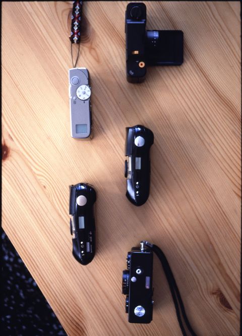 Some of the smallest 35mm film cameras ever created. From the top: Voigtländer Vito C, Minolta TC-1, Olympus Mju Infinity Stylus, Olympus Mju Infinity Stylus Deluxe, Rollei 35. Note how ergonomic the Olympus cameras appear compared to the boxy designs surrounding them.